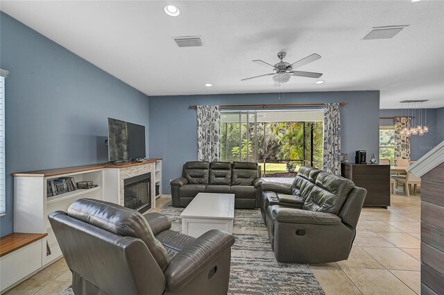 living room with light tile patterned floors and ceiling fan