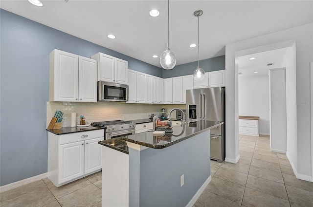 kitchen featuring light tile patterned flooring, pendant lighting, an island with sink, and high quality appliances