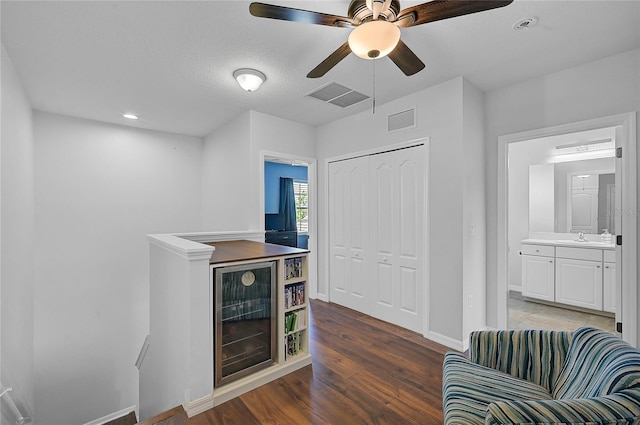 interior space featuring ceiling fan, sink, and wood-type flooring