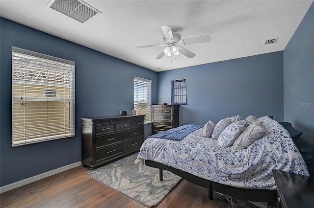 bedroom featuring ceiling fan and dark hardwood / wood-style flooring