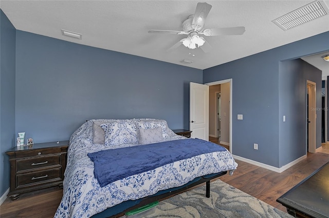 bedroom with ceiling fan and dark hardwood / wood-style floors