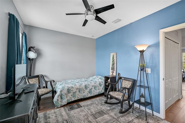 bedroom featuring hardwood / wood-style flooring, a closet, and ceiling fan