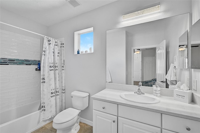 full bathroom featuring ceiling fan, toilet, vanity, tile patterned floors, and shower / tub combo