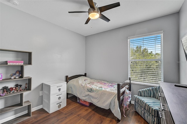 bedroom with ceiling fan and dark hardwood / wood-style floors