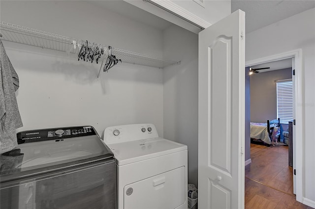 laundry area with ceiling fan, hardwood / wood-style floors, and washer and clothes dryer