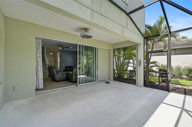 unfurnished sunroom with ceiling fan