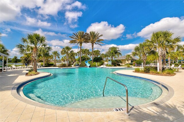 view of swimming pool with a water slide