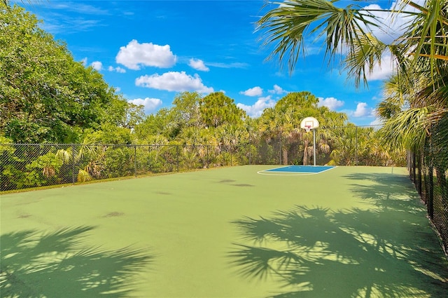 view of tennis court with basketball hoop