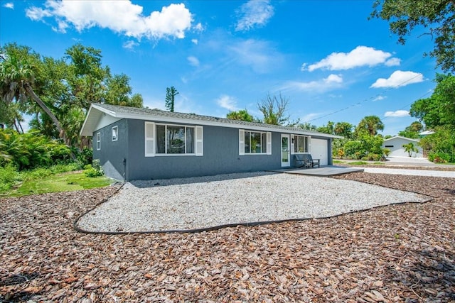 rear view of property featuring a garage