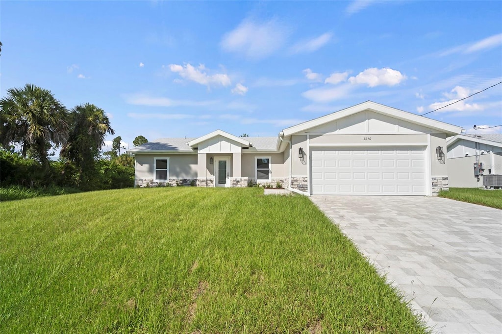 single story home featuring a garage, central AC unit, and a front lawn