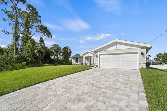 ranch-style house featuring a front lawn and a garage