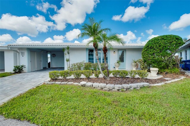 ranch-style house with a carport and a front yard