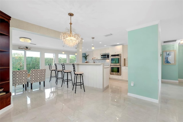 kitchen with pendant lighting, a notable chandelier, white cabinetry, stainless steel appliances, and light tile patterned flooring