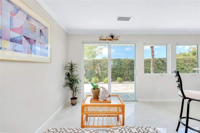 sitting room featuring a healthy amount of sunlight, light tile patterned floors, and ornamental molding