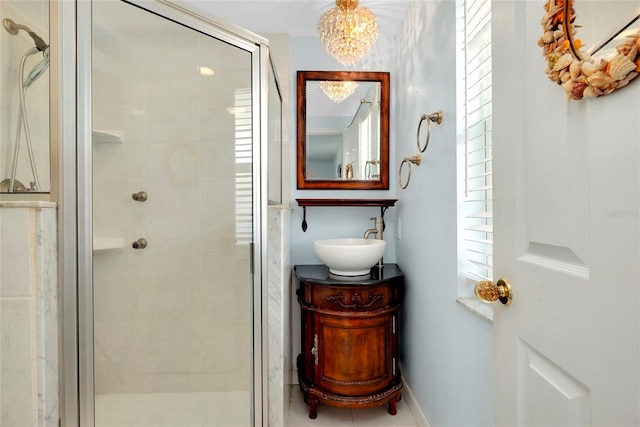 bathroom featuring a shower with door, vanity, and a chandelier