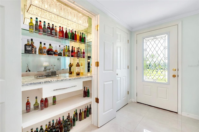 bar featuring crown molding, light stone counters, and light tile patterned flooring