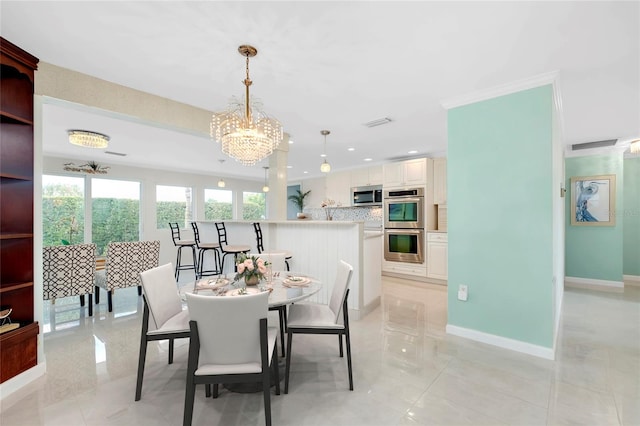 dining space with crown molding, an inviting chandelier, and light tile patterned floors