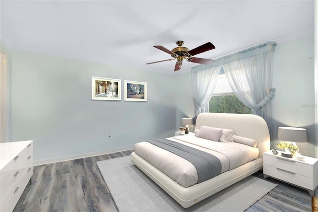 bedroom with hardwood / wood-style floors, ceiling fan, and crown molding