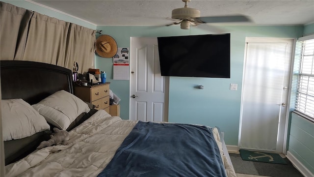 carpeted bedroom featuring ceiling fan and multiple windows