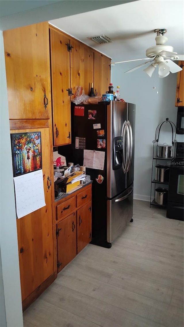 kitchen with ceiling fan, light hardwood / wood-style flooring, stainless steel fridge, and range