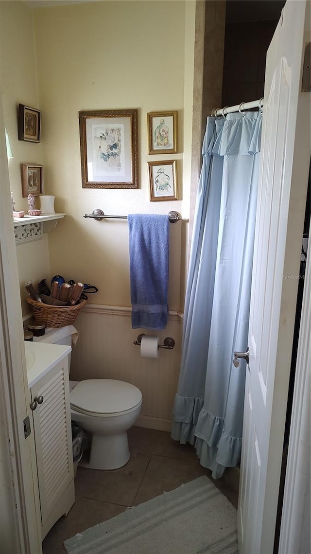 bathroom featuring tile patterned flooring, vanity, and toilet