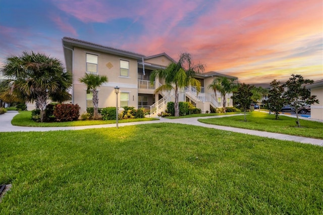 property at dusk featuring stairway