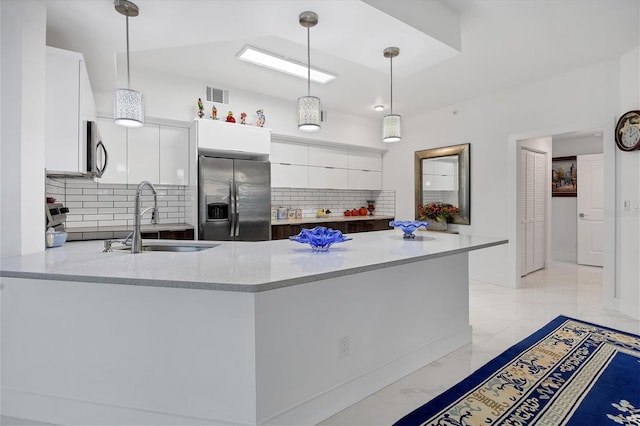 kitchen featuring marble finish floor, visible vents, white cabinets, a sink, and stainless steel fridge