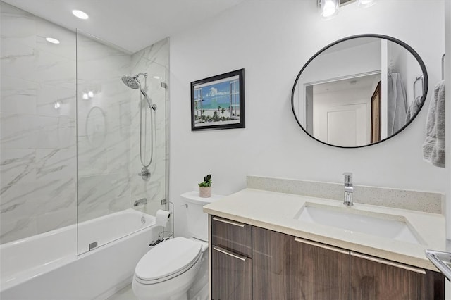 bathroom featuring toilet, combined bath / shower with glass door, and vanity