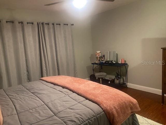 bedroom with ceiling fan and wood-type flooring