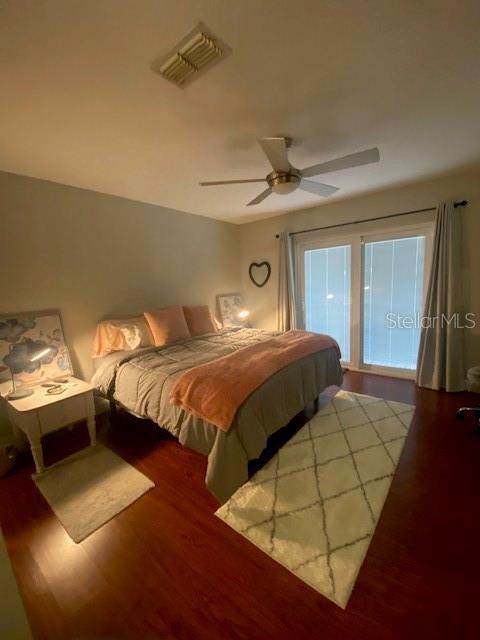 bedroom with ceiling fan and hardwood / wood-style flooring