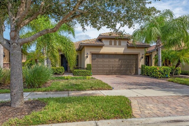 mediterranean / spanish-style home with a garage