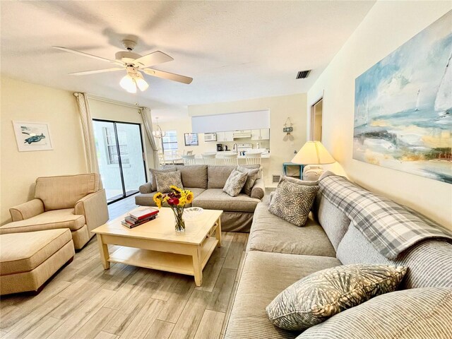 living room featuring ceiling fan and light wood-type flooring