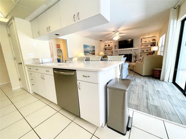 kitchen featuring white cabinetry, ceiling fan, stainless steel dishwasher, kitchen peninsula, and light wood-type flooring