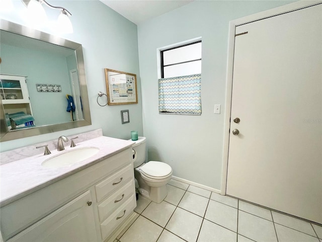 bathroom featuring tile patterned flooring, vanity, and toilet