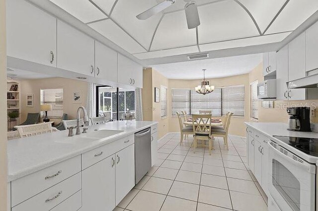 kitchen featuring pendant lighting, white cabinetry, plenty of natural light, and sink