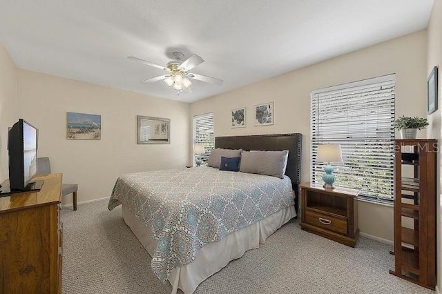 bedroom featuring ceiling fan and light carpet