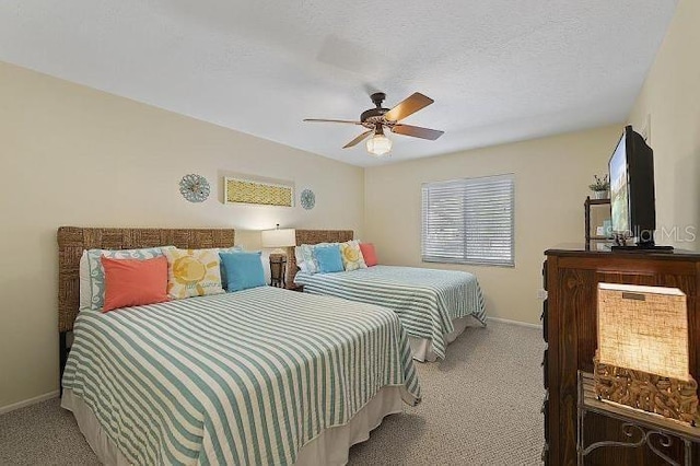 carpeted bedroom with ceiling fan and a textured ceiling