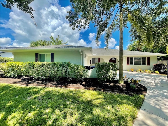 ranch-style home with a front lawn