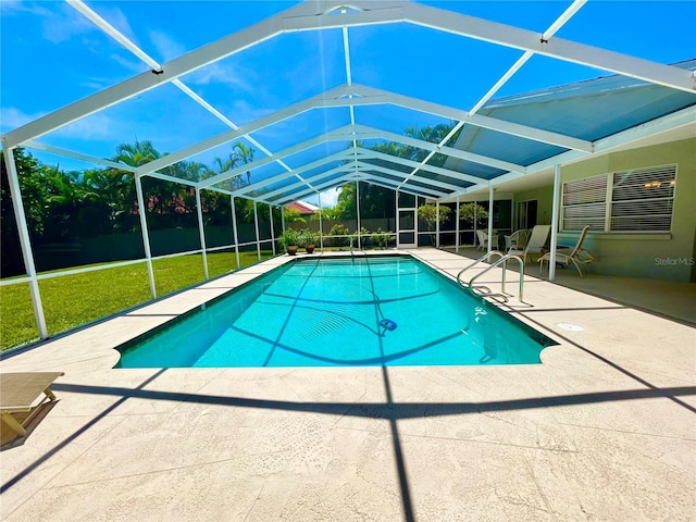 view of swimming pool featuring a patio, glass enclosure, and a lawn