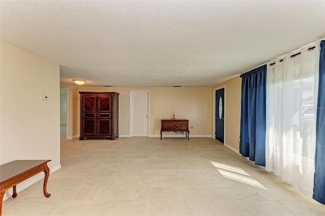 spare room with a textured ceiling