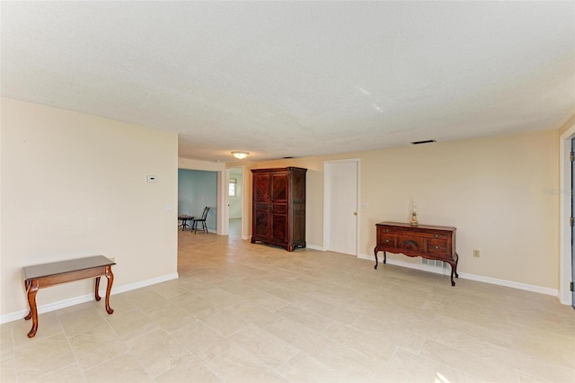 unfurnished room featuring a textured ceiling