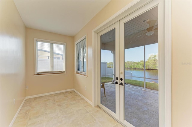 doorway with a water view and french doors