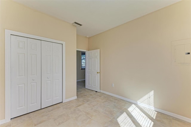 unfurnished bedroom featuring a closet and electric panel