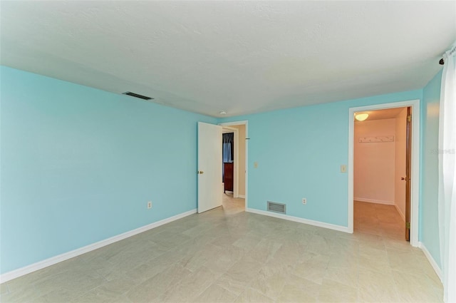 spare room with a textured ceiling