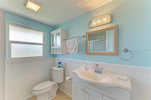 bathroom with toilet, tile patterned floors, an enclosed shower, and vanity