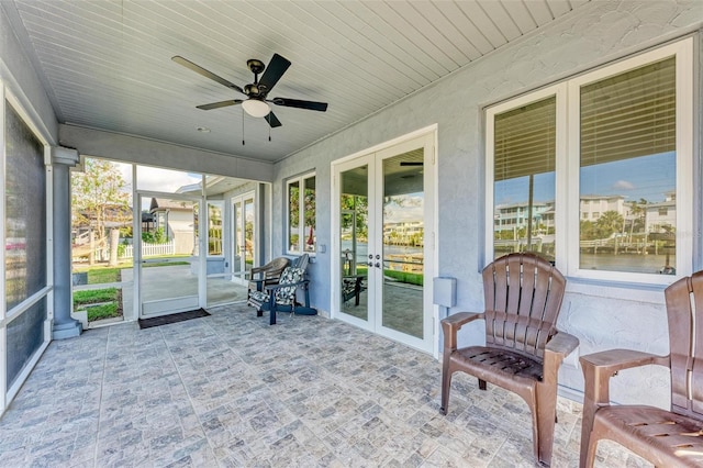 sunroom featuring ceiling fan and wood ceiling