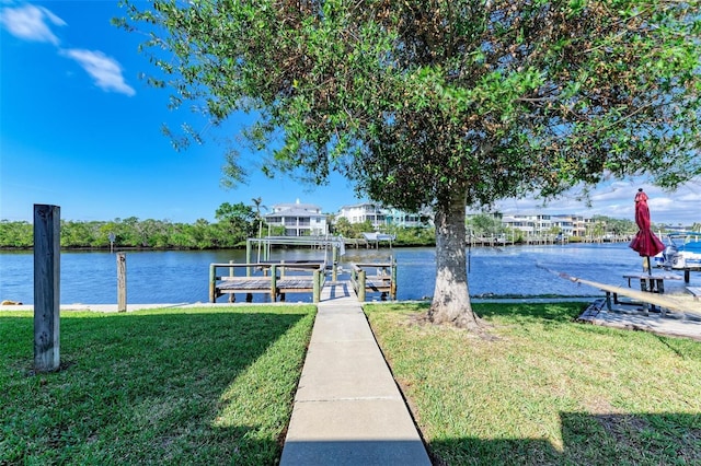 dock area featuring a yard and a water view