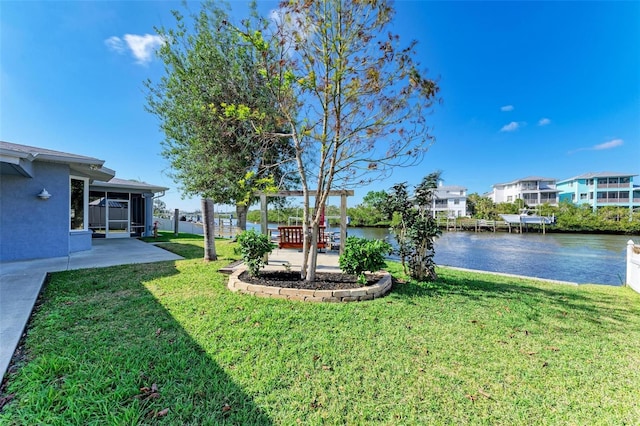 view of yard with a water view and a patio area