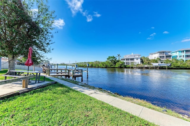 dock area featuring a yard and a water view