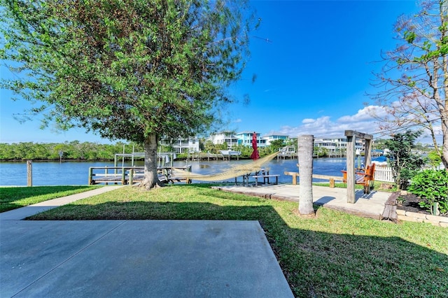 dock area with a yard and a water view